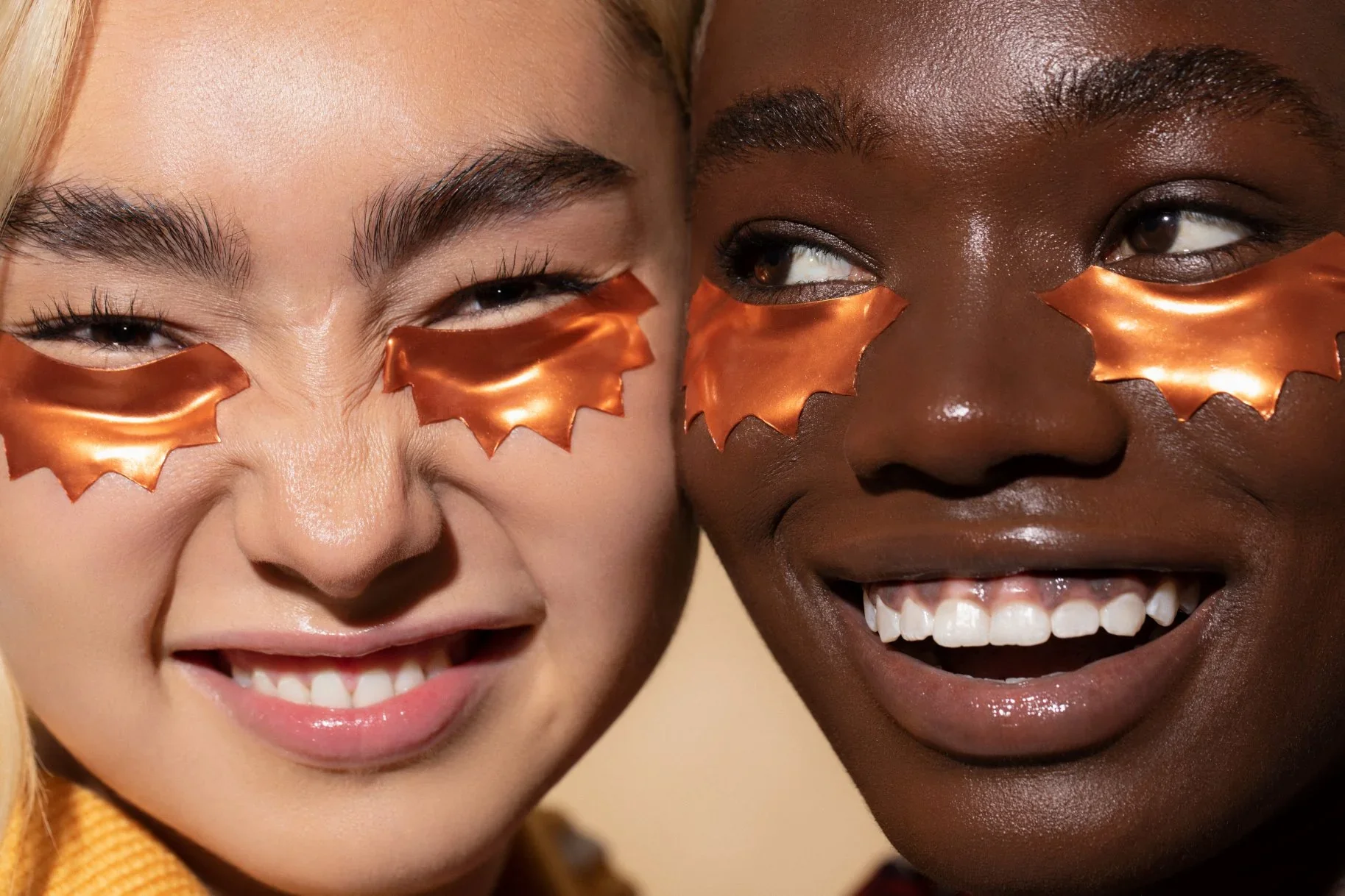 Two people smiling with Rays Copper Peptide Eye Masks under their eyes